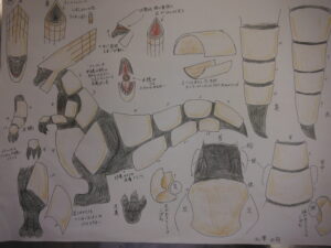 二足歩行する怪獣の全身像に加え、各部位の構造や断面、背中の節状のパーツの詳細などが細かく描き込まれたイラスト