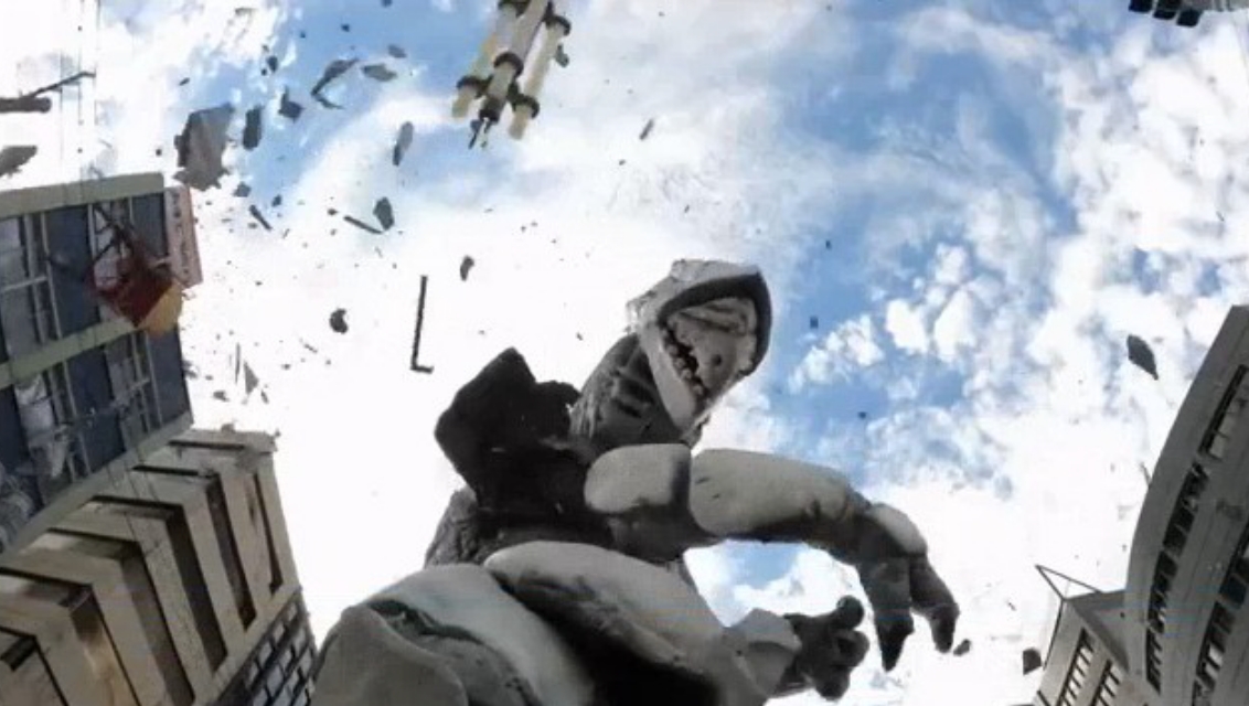 崩れ落ちる建物の破片が空中を舞い、巨大な怪獣スーツが立っている様子を下からの視点で撮影した写真